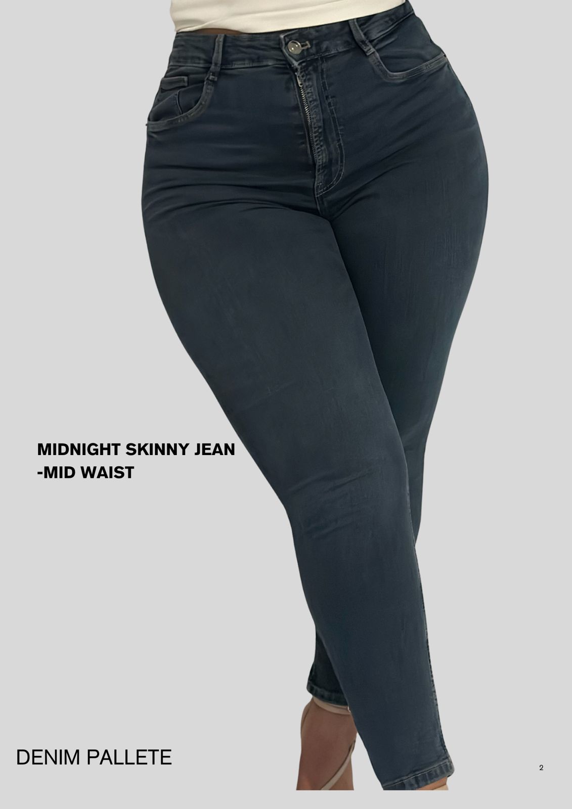 Indigo skinny jeans on a gray background with text indicating 'Midnight Skinny Jean - Mid Waist' and 'Denim Palette'.